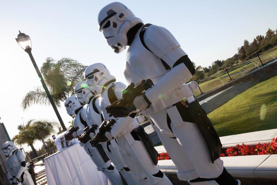 A line of stormtroopers from the 501st Legion stand guard as the wedding party for an offbeat Star Wars wedding with Let's Get Married by Marie