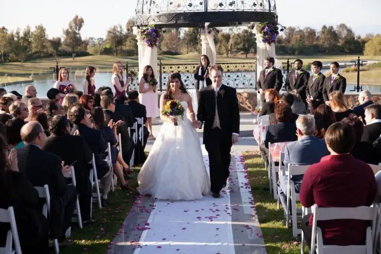 A smiling newlywed couple recesses away from their Star Wars wedding ceremony with offbeat wedding officiant Let's Get Married by Marie
