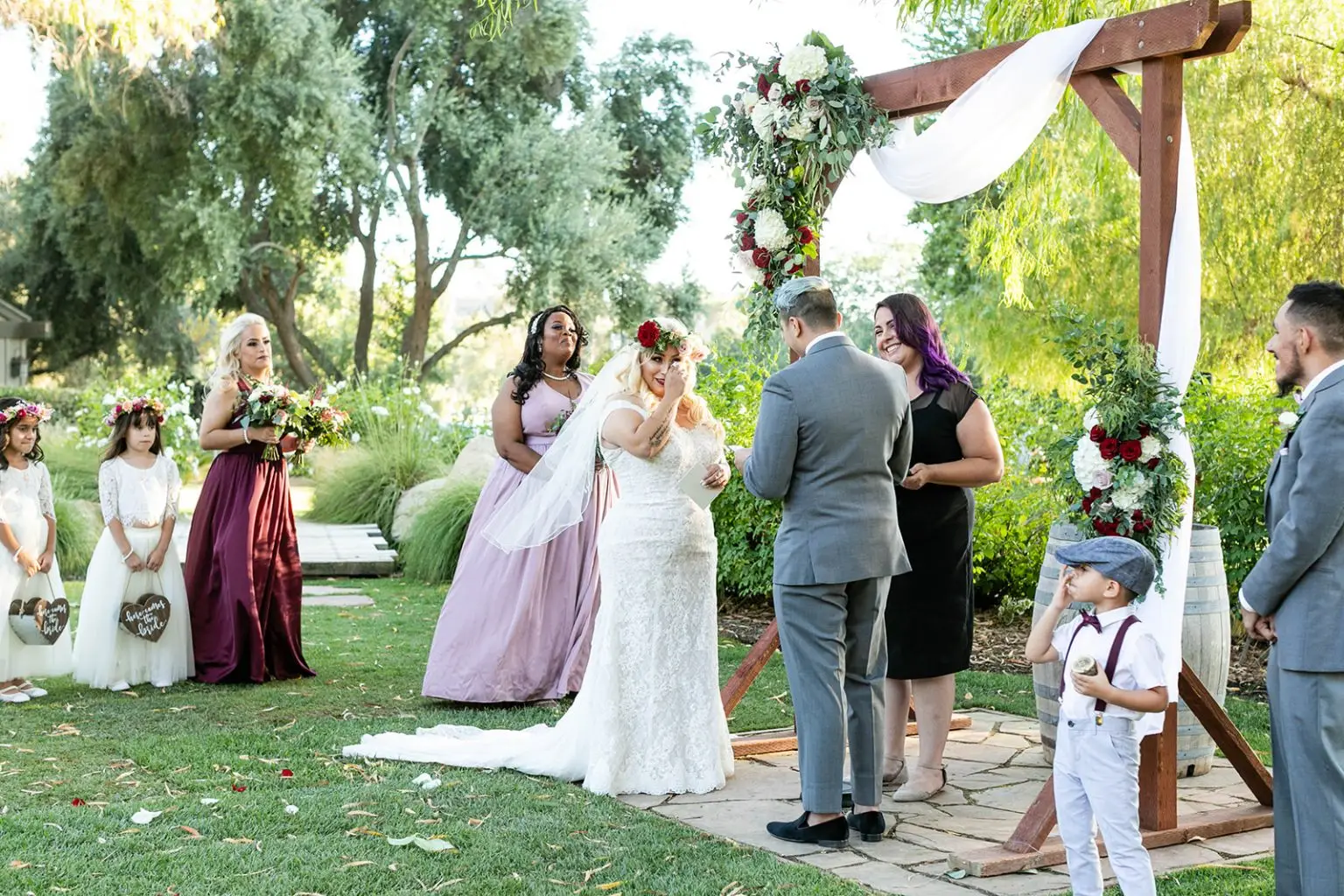 Temecula wedding officiant Let's Get Married by Marie leads a wedding with a bride drying her eyes and a smiling groom