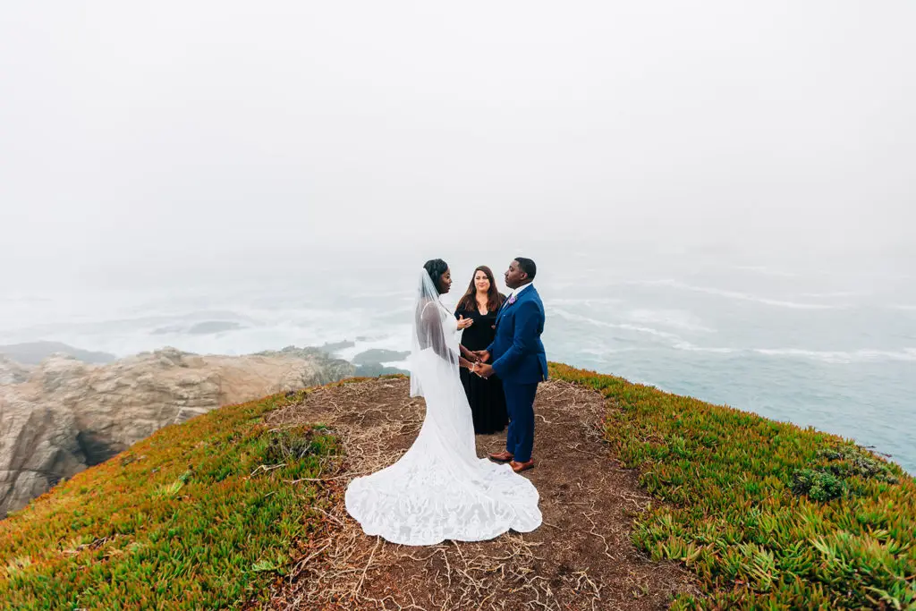 Big Sur elopement package with a bride and groom on a cliff with Let's Get Married by Marie