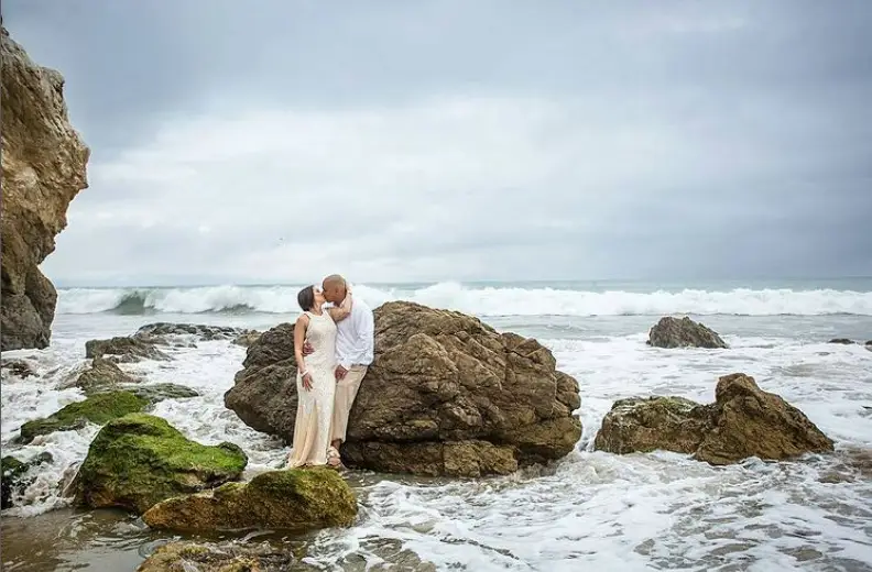 Los Angeles beach elopement packages with Let's Get married by Marie feature a bride and groom in white on the beach in the surf