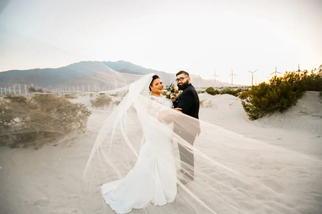 Palm Springs elopement packages with Let's Get Married by Marie featuring a bride and groom at the Palm Spring windmills and sand dunes