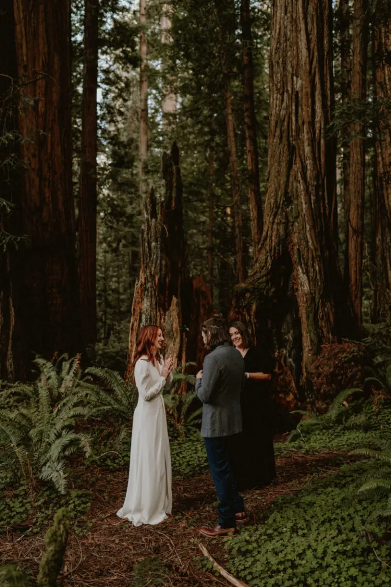 Redwood elopement packages by Let's Get Married by Marie show a red-headed bride and a suited groom getting married in a redwood grove